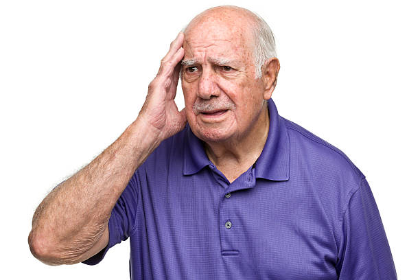Older man scratching head